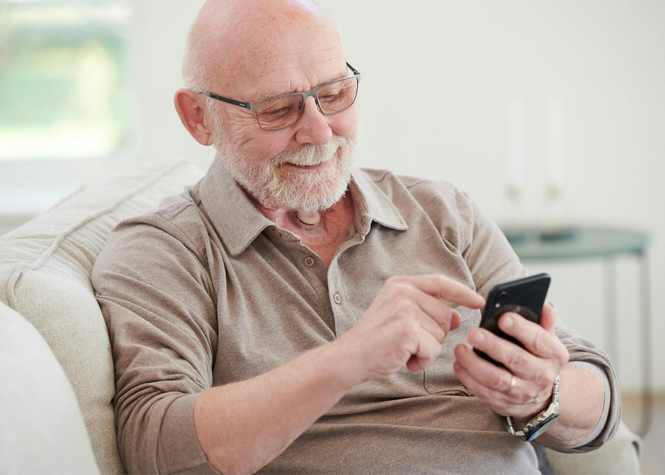 Laryngectomy patient looking at phone