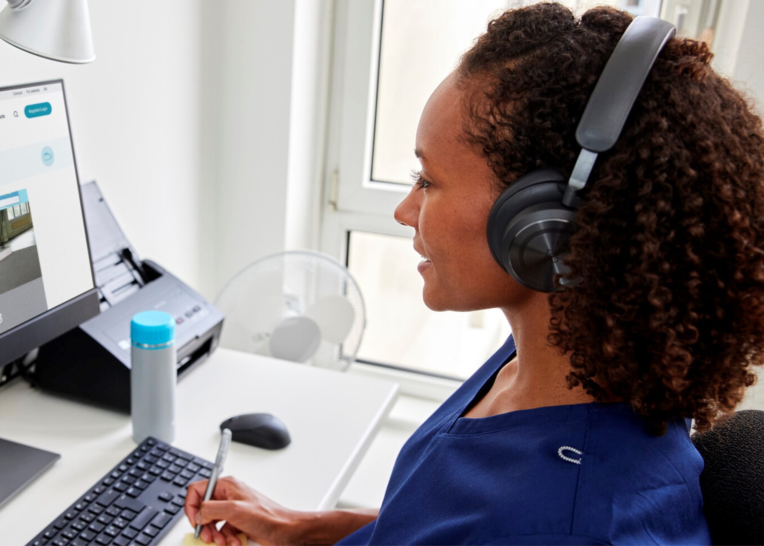 healthcare professional in front of screen with headphones on